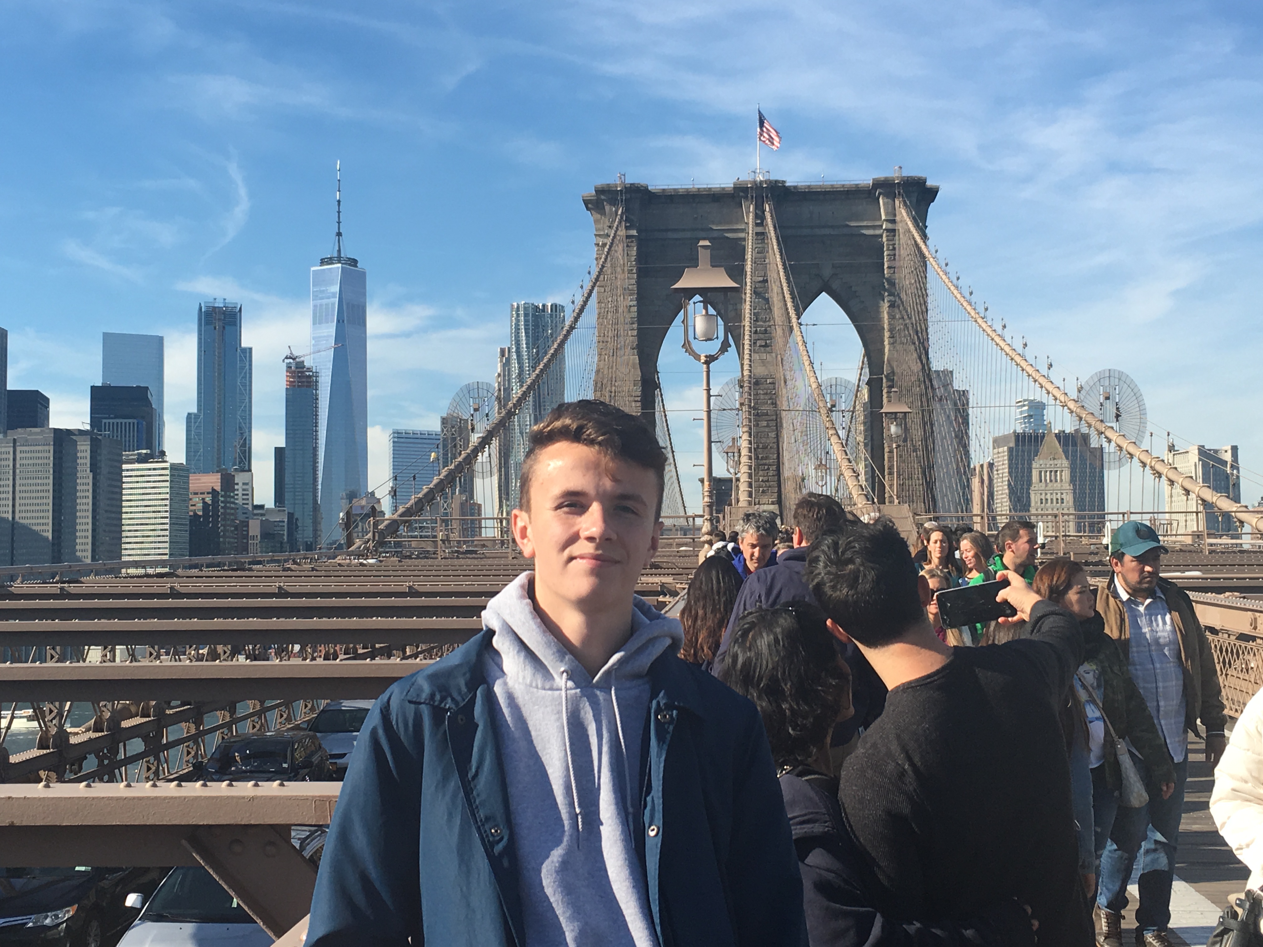 Riley on the Brooklyn Bridge with Manhattan in the background