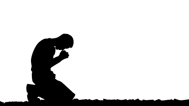 A man kneeling in prayer